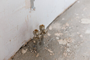 Plumber fixing white sink pipe with adjustable wrench.