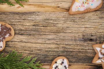 Christmas homemade gingerbread cookies and Christmas tree on a wooden background