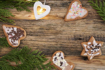 Christmas homemade gingerbread cookies and Christmas tree on a wooden background