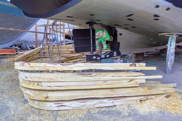 Back of boat with wooden beams at shipyard