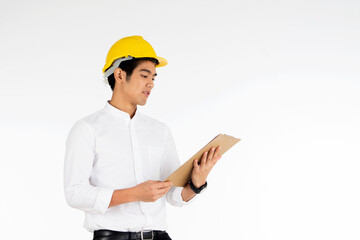 Portrait of handsome engineer wearing a yellow helmet at work and carrying a document on a white background