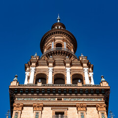 Obraz premium It's South tower of the Central building at the Plaza de Espana in Seville, Andalusia, Spain. It's example of the Renaissance Revival style in Spanish architecture.