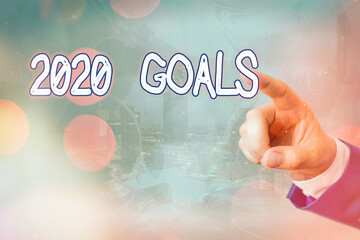 Writing note showing 2020 Goals. Business concept for a targeted list of ambitions that need to be...