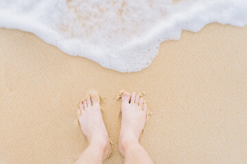 feet standing on the beach, summer time