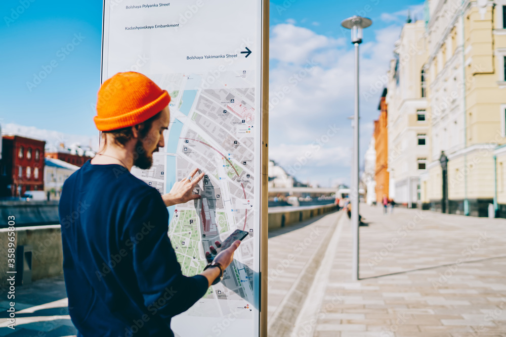 Poster youthful tourist installing application with city map for tracking gps during touristic sightseeing 