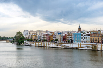 It's Guadalquivir river coast and architecture of Seville, Andalusia, Spain.