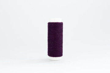 spool of black thread on a white background