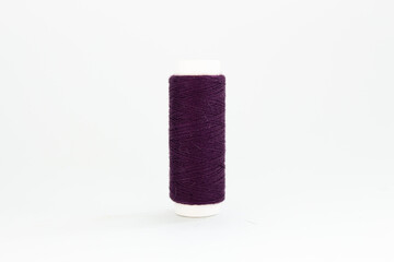 spool of purple thread on a white background