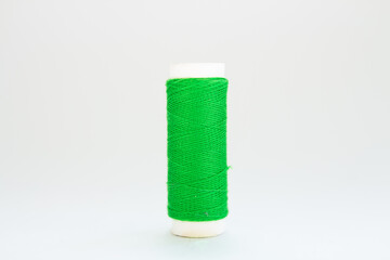 skein of green thread on a white background
