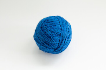 ball of blue thread on a white background