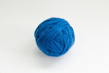 ball of blue thread on a white background