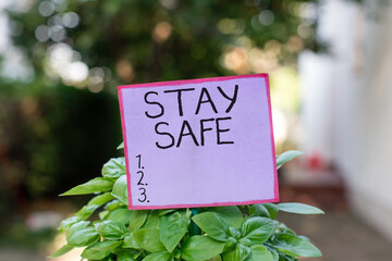 Conceptual hand writing showing Stay Safe. Concept meaning secure from threat of danger, harm or...