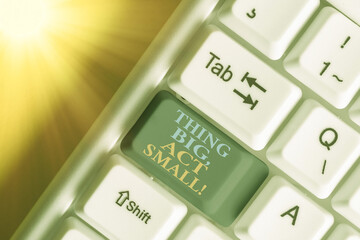 Writing note showing Thing Big, Act Small. Business concept for Starts at a short term to reach a...