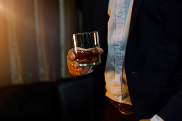 Closeup businessmen holding a glass of whiskey