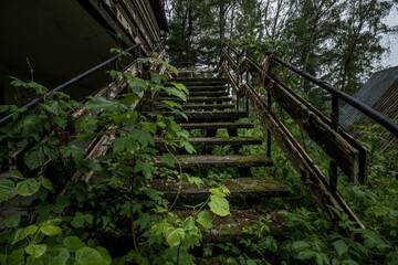 Stairs leading to one of the buildings in the abandoned resort located in the middle of the forest