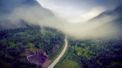 Empty road. rocky road goes into the distance into the blue sky. mountain road in the summer. Mountain pass in Norway. Top view