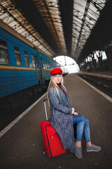 Fototapeta premium Lady in a red cap and with a red bag, urban geometry.