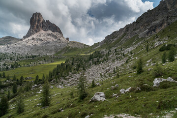 Dolomite landscape with mountain in front of dramatic sky and mountains.
