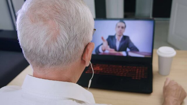 Senior Man Having Video Conference On His Laptop. Online Webinar Or Online Training For Pensioners. Communication Remotely Using A Computer