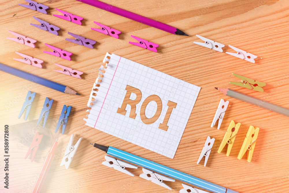 Poster writing note showing roi. business concept for performance measure used to evaluate the efficiency o