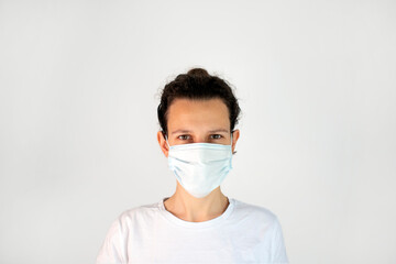 Woman wearing a face mask isolated on white background. Illustrative editorial photo with space for writing.