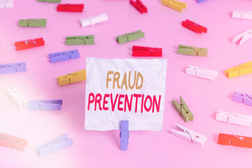 Writing note showing Fraud Prevention. Business concept for to secure the enterprise and its processes against hoax Colored clothespin papers empty reminder pink floor office pin