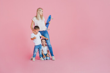 Beautiful blonde mom with two happy sons. Young woman and two baby boys,