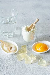 Products (collagen powder, gelatin, yolk) which contain collagen.Diced gelatin.Collagen powder on a light background. Extra protein intake. Natural beauty and health supplement for skin, bones, joints