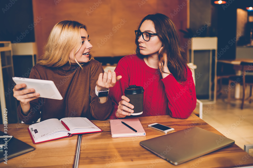 Poster young woman gesturing while explaining point of view to colleague preparing coursework with, student