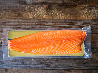 Fresh raw salmon fillet on wooden board 

