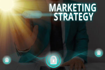 Handwriting text writing Marketing Strategy. Conceptual photo plan of action designed to promote...