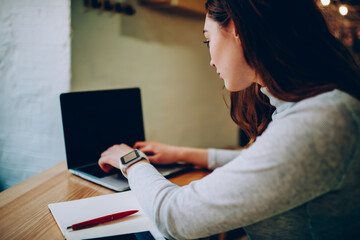 Professional female freelancer typing on laptop computer working distantly on development in coworking space,skilled woman keyboarding publication for blog content updates browse web page on netbook.