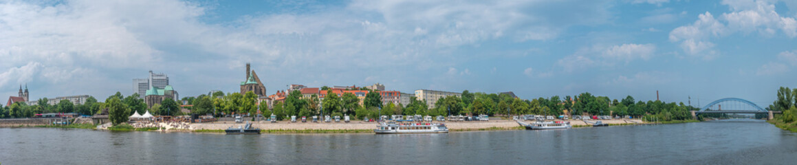 Fototapeta na wymiar Panoramic view over beach cafes, restaurants and camping site for campers at the downtown near Elbe river in Magdeburg, Germany, 2020 Summer