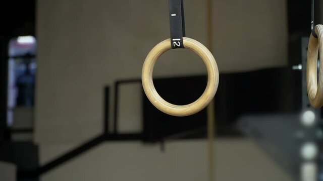 Wooden gymnastic rings. Sport equipment. Gym and rocking chair. High quality FullHD footage