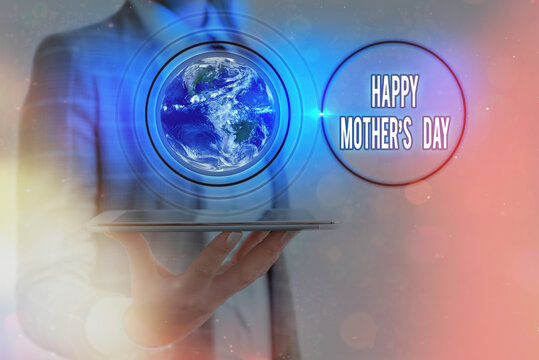 Writing note showing Happy Mothers Day. Business concept for celebrated in honor of the motherhood s is influence in society Elements of this image furnished by NASA
