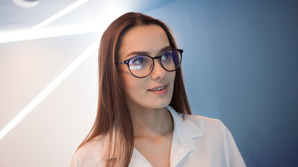 Young stylish girl portrait on blue background.