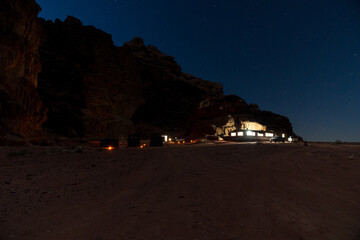 Bedouin camp on Wadi Rum desert, Jordan at night.  Bedouin tents in front of a mountain.