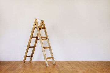 Wooden ladder in an empty loft style room with space for text. Realistic blank for interior design.