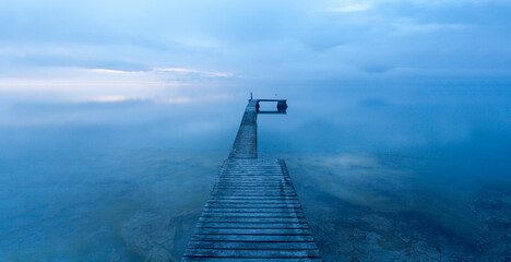 Optical illusion, a bathing jetty seem to float in the air when the sea meets the sky on a magical summer evening at the island of Gotland, Sweden