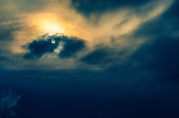 Naklejka na ściany i meble Peaceful twilight scene - sky with clouds and partly hidden sun ball