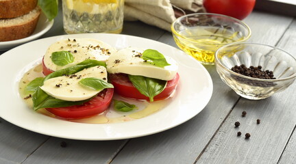 Caprese salad of tomato, mozzarella, basil. Italian food.
