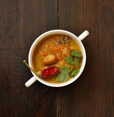 Dal, red lentil soup with turmeric, garlic, chili and cilantro. Indian food,  top view, copy space