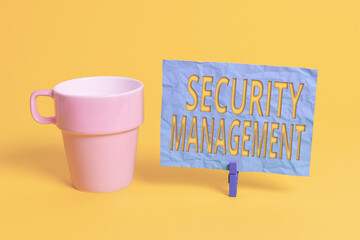 Handwriting text Security Management. Conceptual photo is the identification of an organization s is assets Cup empty paper blue clothespin rectangle shaped reminder yellow office