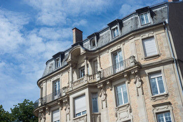 Fototapeta na wymiar retail of luxury stoned building facade on beautiful cloudy sky