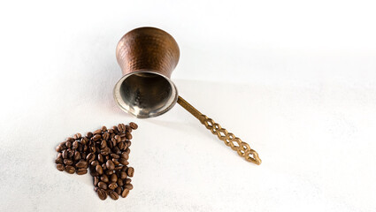 coffee beans and Turk on a white scuffed background. The concept of a popular invigorating drink...