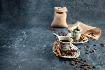 composition with Arabica coffee in light cups, unusual shape, on a dark graphite background. the concept of making coffee at home. selective focus.