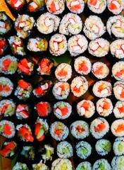 Overhead japanese sushi food. Maki ands rolls with tuna, salmon, shrimp, crab and avocado. Top view of assorted sushi, all you can eat menu. Rainbow sushi roll, uramaki, hosomaki and nigiri. Homemade.