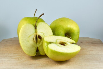 green apples on a wooden board