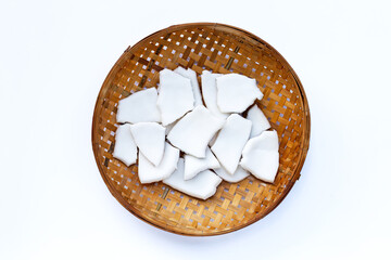 Coconut pieces on wooden bamboo threshing basket on white