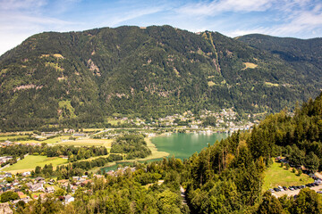 Panorama from Ossiacher lake with the mountain Gerlitzen in the background in sunny weather in Carinthia, Austria in Europe